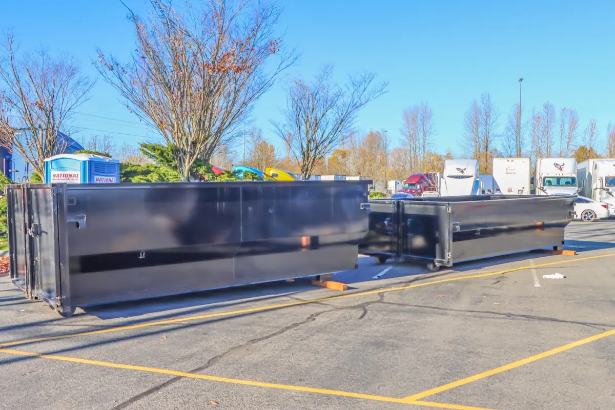 Professional dumpster rental service with roll-off container on residential driveway in Big Lake